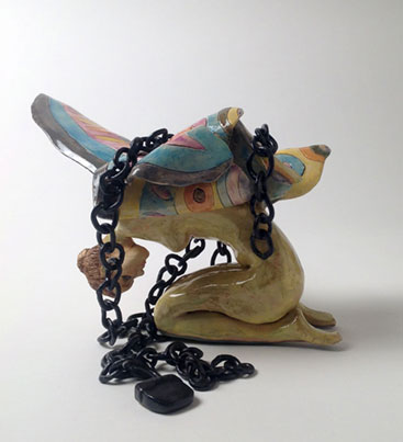 Ceramic fairy sculpture with chains.