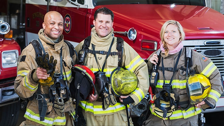 Cecil College Fire Science Technology Degrees - Three firefighters standing in front of a fire truck.