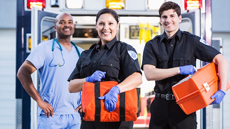 Cecil College Paramedic Degrees - Two EMTs and a ER nurse standing at the back of an ambulance.