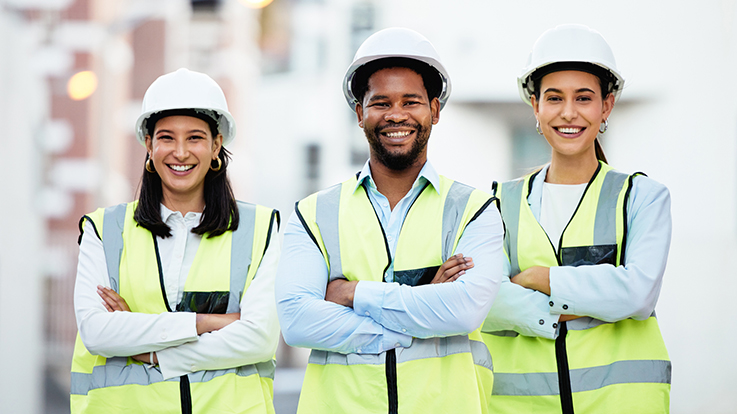 Cecil College Skilled Trades Degree - Workers standing with their arms crossed and wearing hard hats and reflective safety vests.