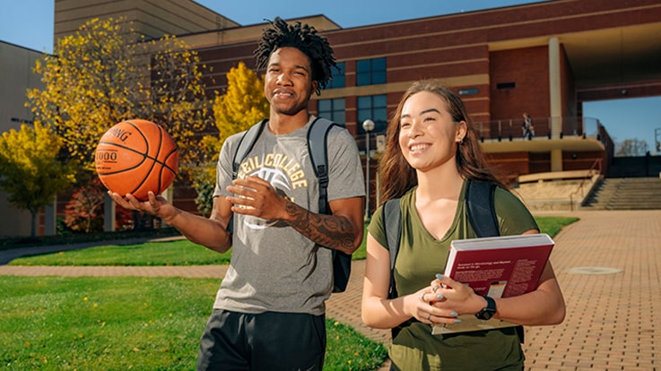 Cecil College Sports Management Degrees - Two students walking together outside.
